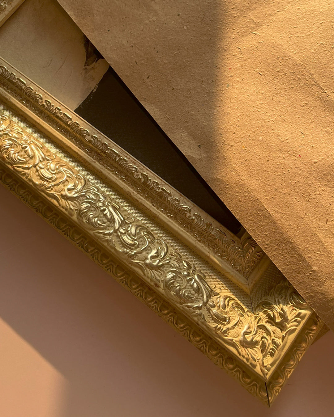 Close-up of beige gold vintage frame with ornate detailing