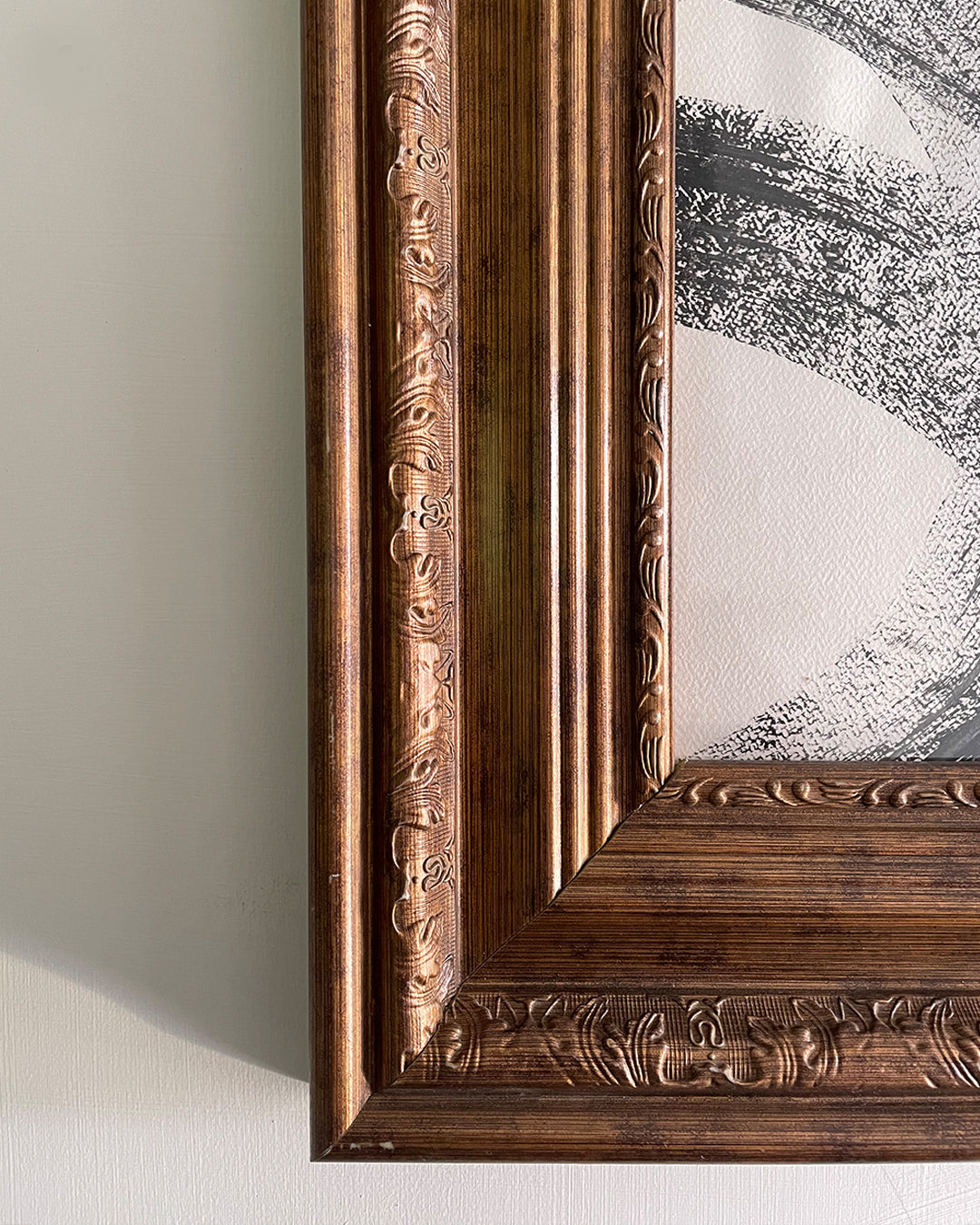 Close-up of 4-inch molding and museum-glass glazing on brown wooden frame