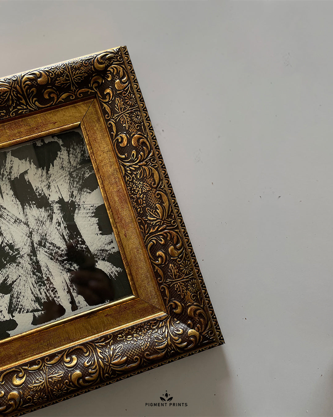 Angled view of GOLD STAIN frame with shadow and wall mount