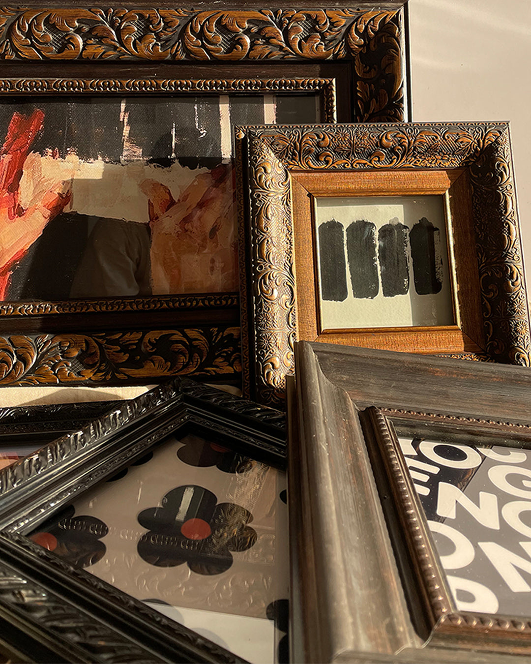 a vintage frame set with ornate design, museum glass, and wood finish.