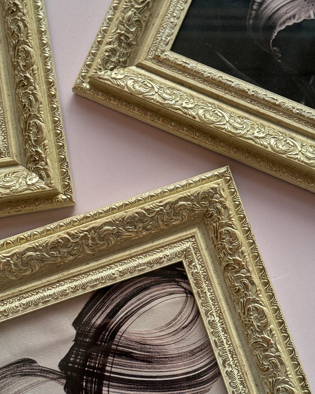 Digital painting displayed in beige gold frame against wall