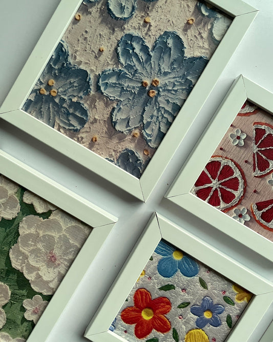 Floral artwork frames laid out on neutral background showcasing full set