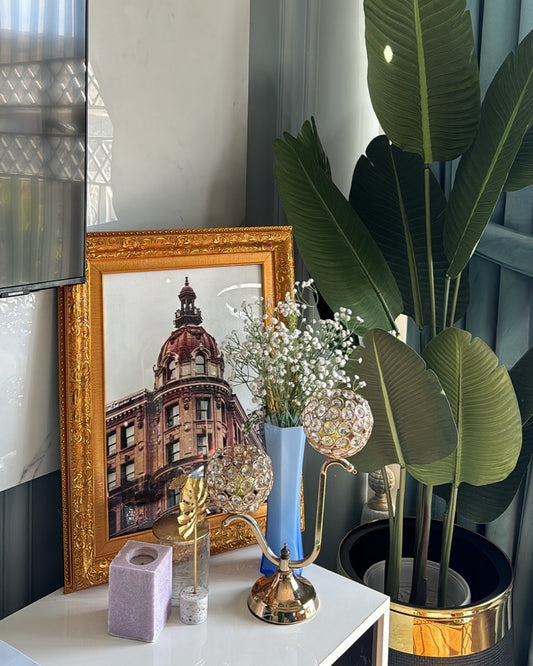 Luxe gold picture frame styled in a cozy living room corner