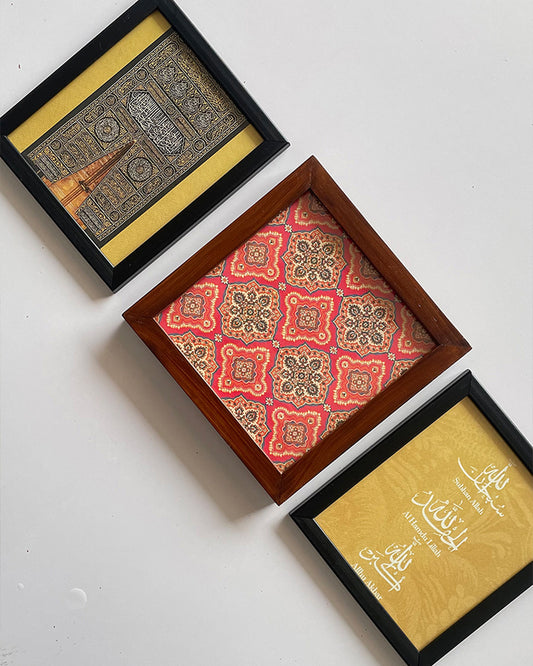 Set of three mini framed paintings in gold accents on white surface